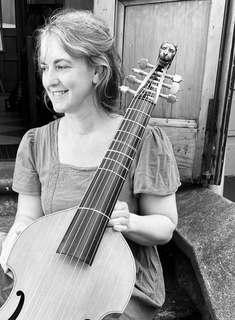 Imogen Granwal, seated, with bass viol